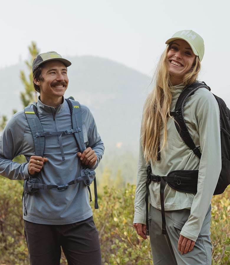 Man and woman hiking in Helly Hansen midlayers