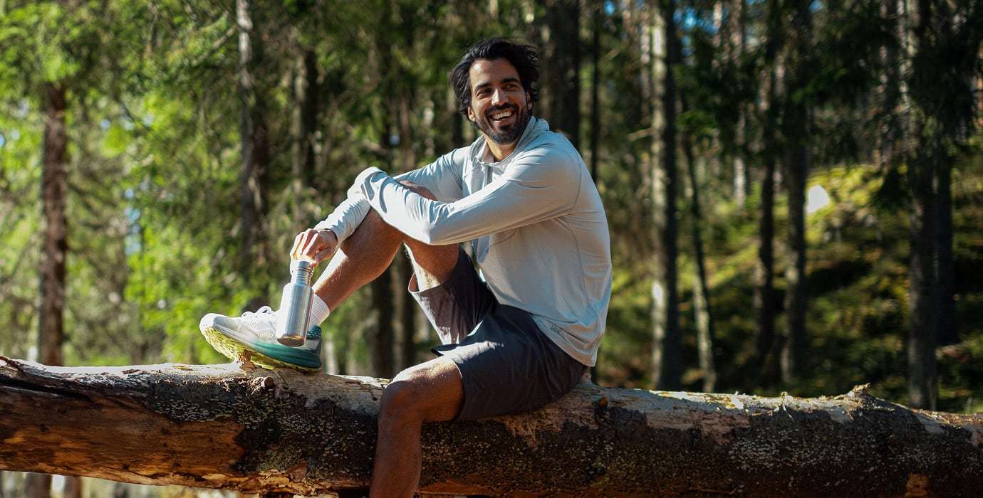 Man in the forest, wearing UPF clothing from Helly Hansen