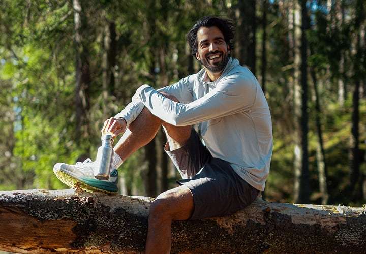 Man in the forest, wearing UPF clothing from Helly Hansen