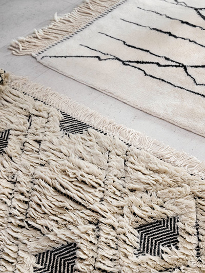 Two beige unique rugs