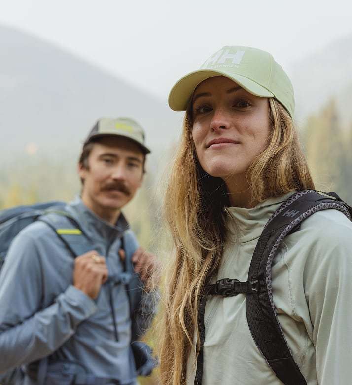 Man and woman hiking in Helly Hansen gear