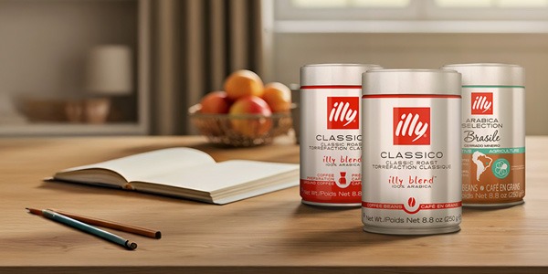 Can of illy coffee on a counter with a woman carrying an illy travel mug