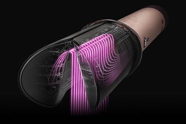 L’accessorio Dyson AirSmooth2x con immagini rosa che mostrano il flusso d’aria tra i bracci dell’accessorio.