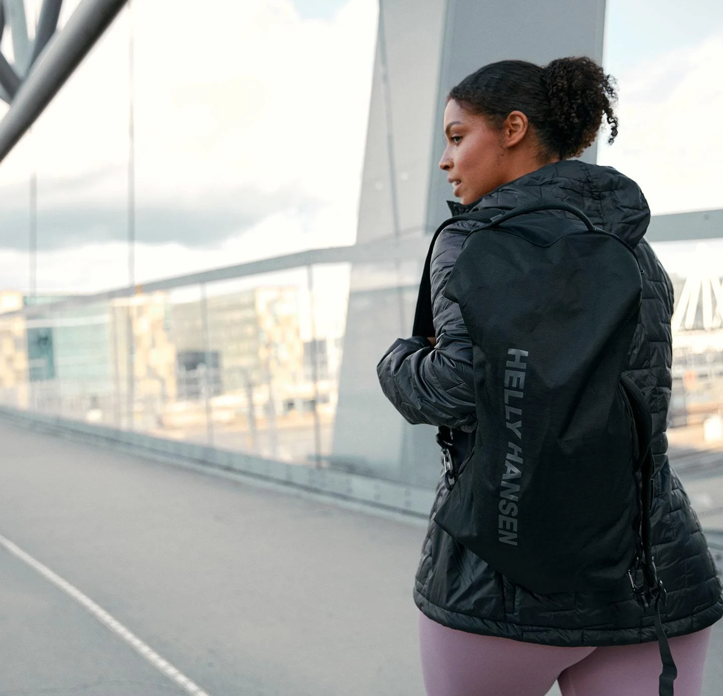 Woman wearing Helly Hansen backpack in the city