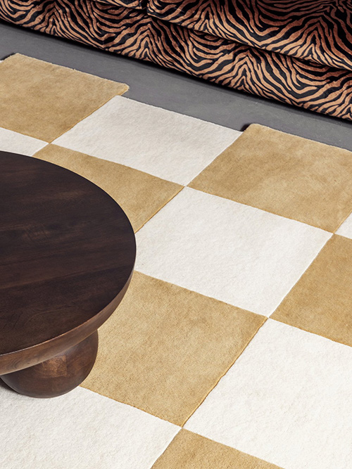 White and beige irregular checkered rug in a living room