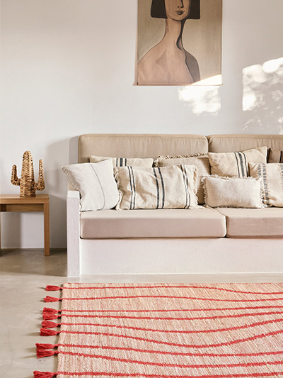White rug with dark blue flowers in a living room
