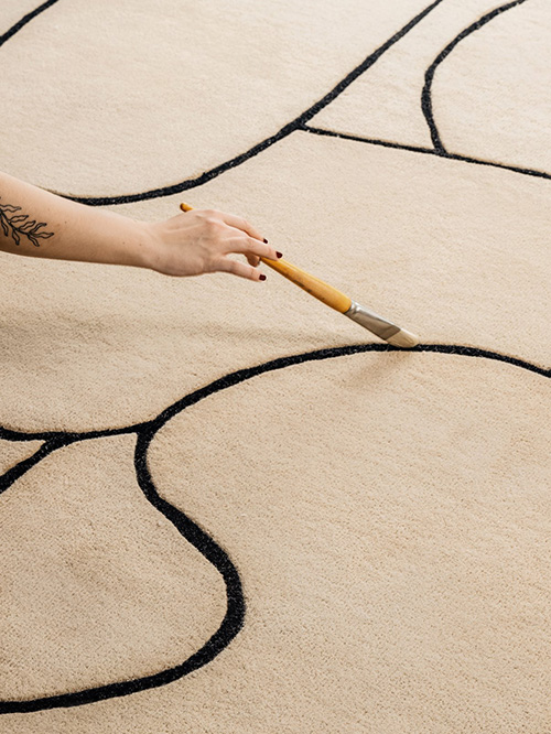 Close up on a beige rug with black lines