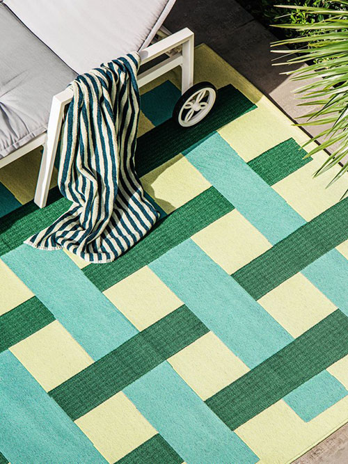 Green outdoor rug by the poolside