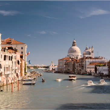 Canal with boats in Venice.
