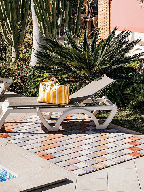 Red and white checkered outdoor rug in an outdoor space