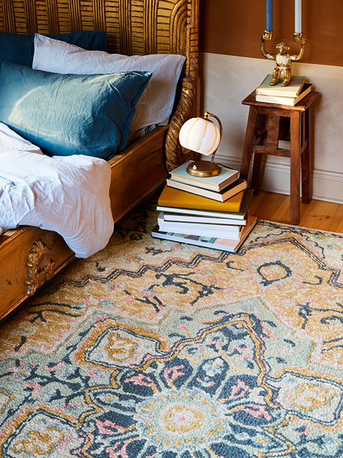 Eclectic styled rug in a bedroom
