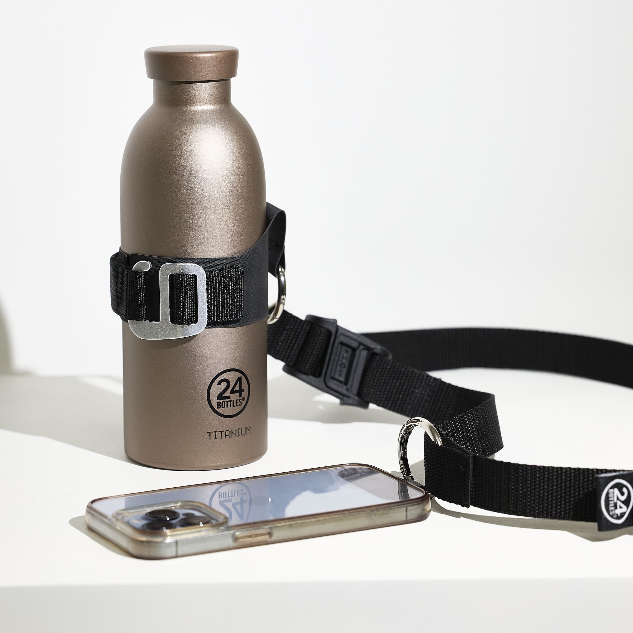 A Titanium Bottle is securely placed inside the Shoulder Strap, designed by 24Bottles in collaboration with Casba.