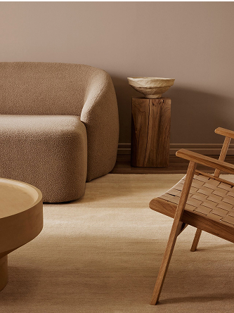 Single coloured beige rug in a living room