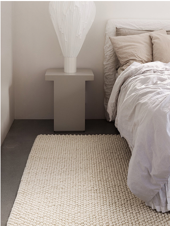 White handmade rug in a bedroom