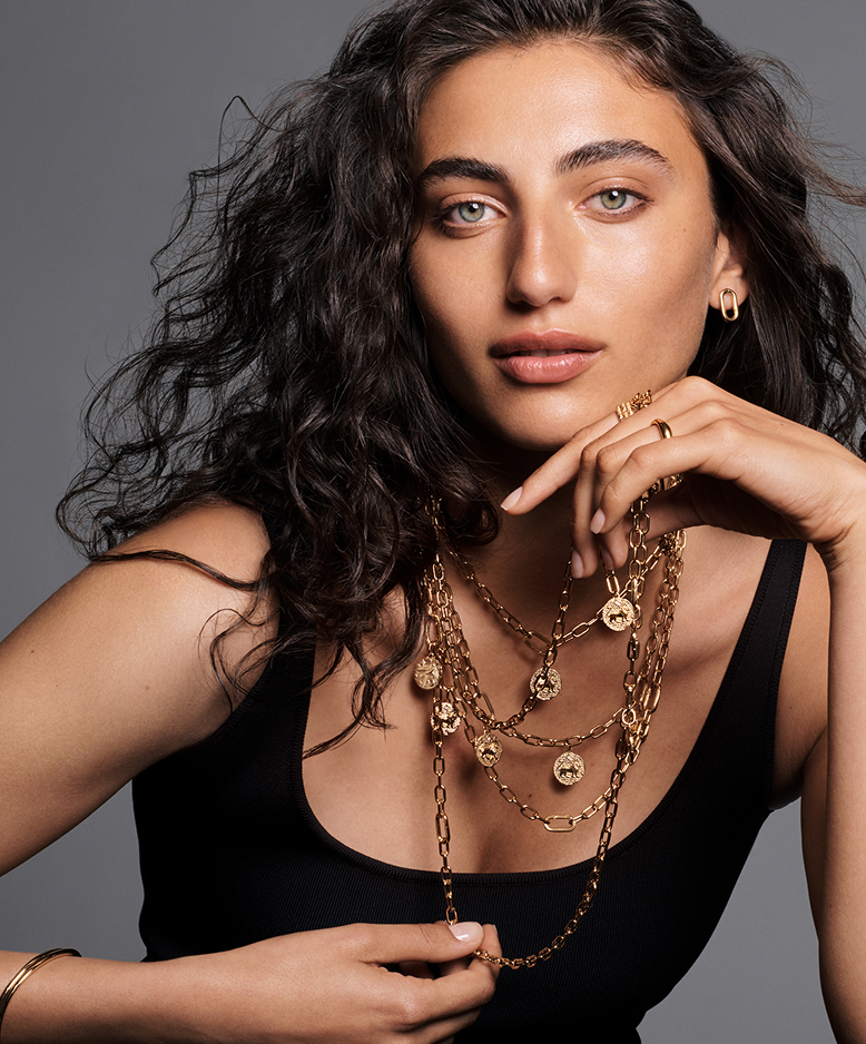 Model styled in layered Pandora Talisman necklaces