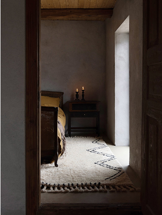 Shaggy white rug in a rustic bedroom