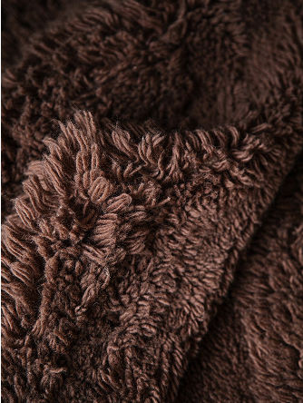 Close up on a shaggy brown rug