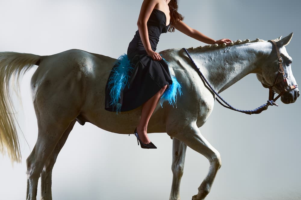 Immagine di una donna sul cavallo che indossa tacchi della nuova collezione.