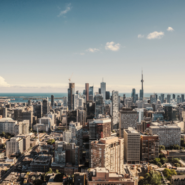 Cityscape with skyscrapers and a TV tower in the background.