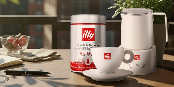 Can of illy coffee on a counter with a woman carrying an illy travel mug