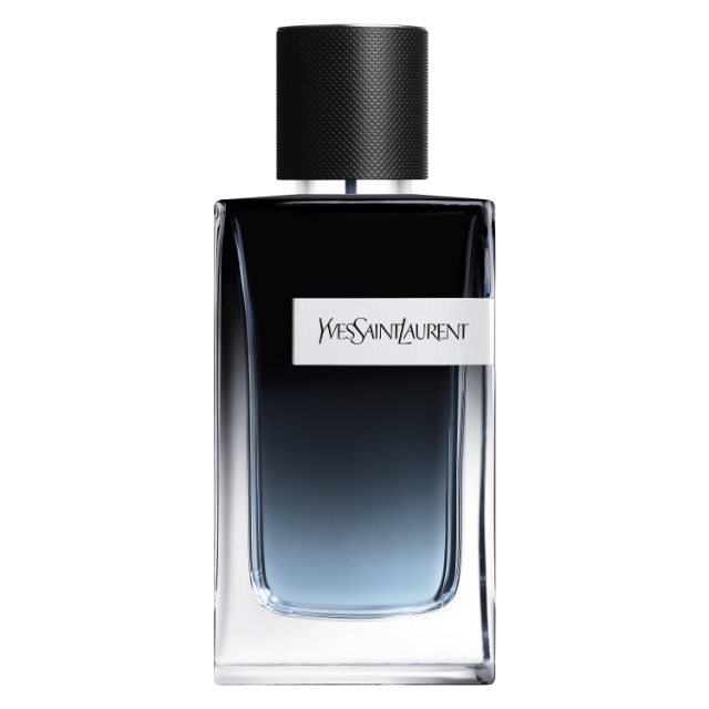 Primo piano del flacone di profumo da uomo "Y" di Yves Saint Laurent. Il flacone in vetro trasparente presenta una sfumatura blu profonda alla base e ha un tappo nero testurizzato. Il logo YSL è visibile su un'etichetta argentata al centro