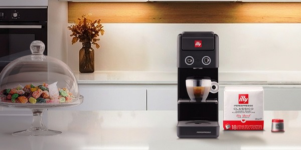 illy whole bean Classico and Intenso cans on a counter