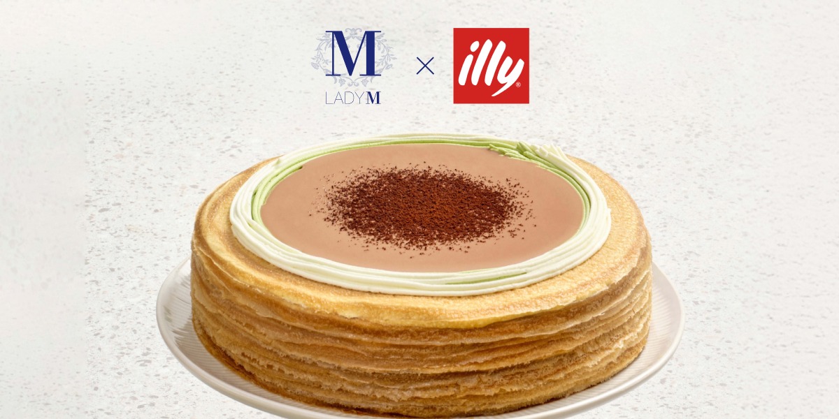 Can of illy coffee on a counter with a woman carrying an illy travel mug