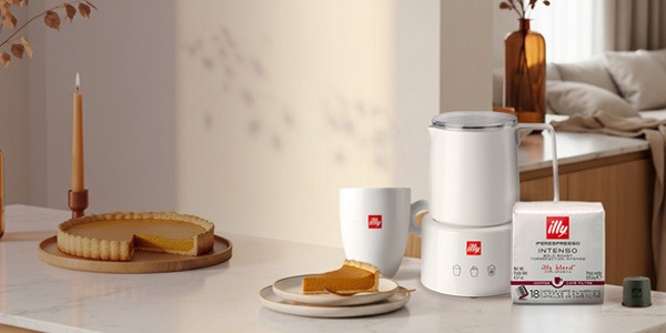 Can of illy coffee on a counter with a woman carrying an illy travel mug