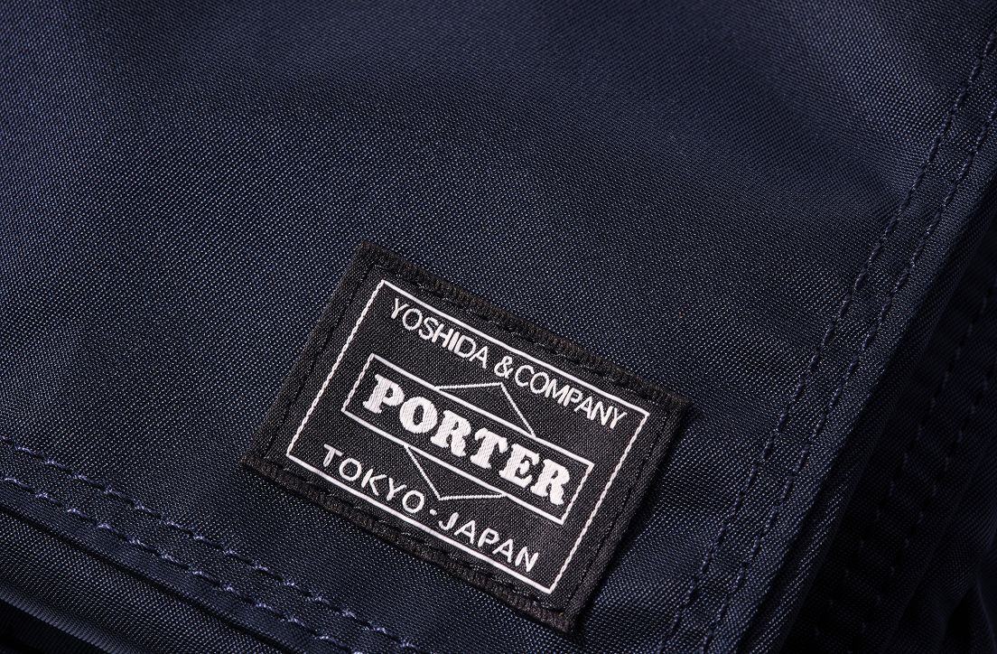 An extreme close up of the PORTER authenticity label on the shoulder bag.