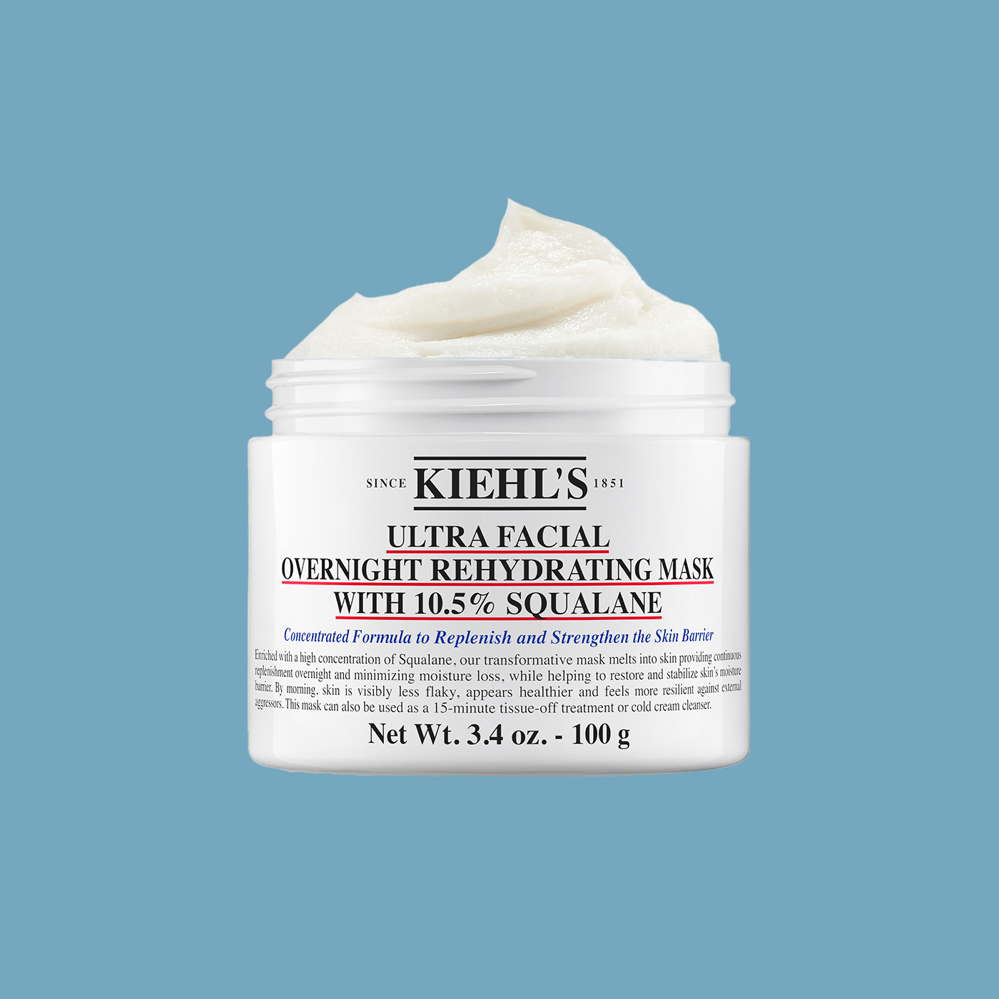 Flacone di Midnight Recovery Concentrate posato su tessuto chiaro con rametti di lavanda accanto.