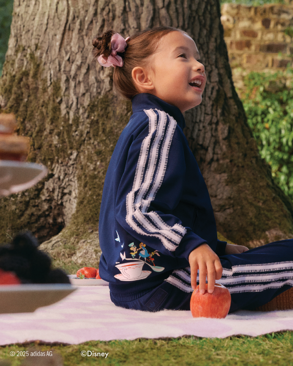 Girl sitting on a blanket in blue tracksuit
