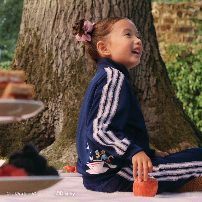 Girl sitting on a blanket in blue tracksuit