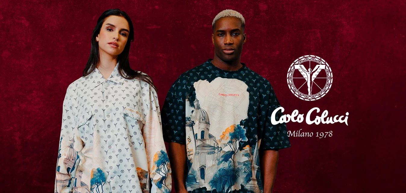 Due modelli indossano camicie oversize. La prima è di colore crema con un motivo e arte paesaggistica; la seconda è nera con un'opera d'arte audace e pantaloni bianchi.