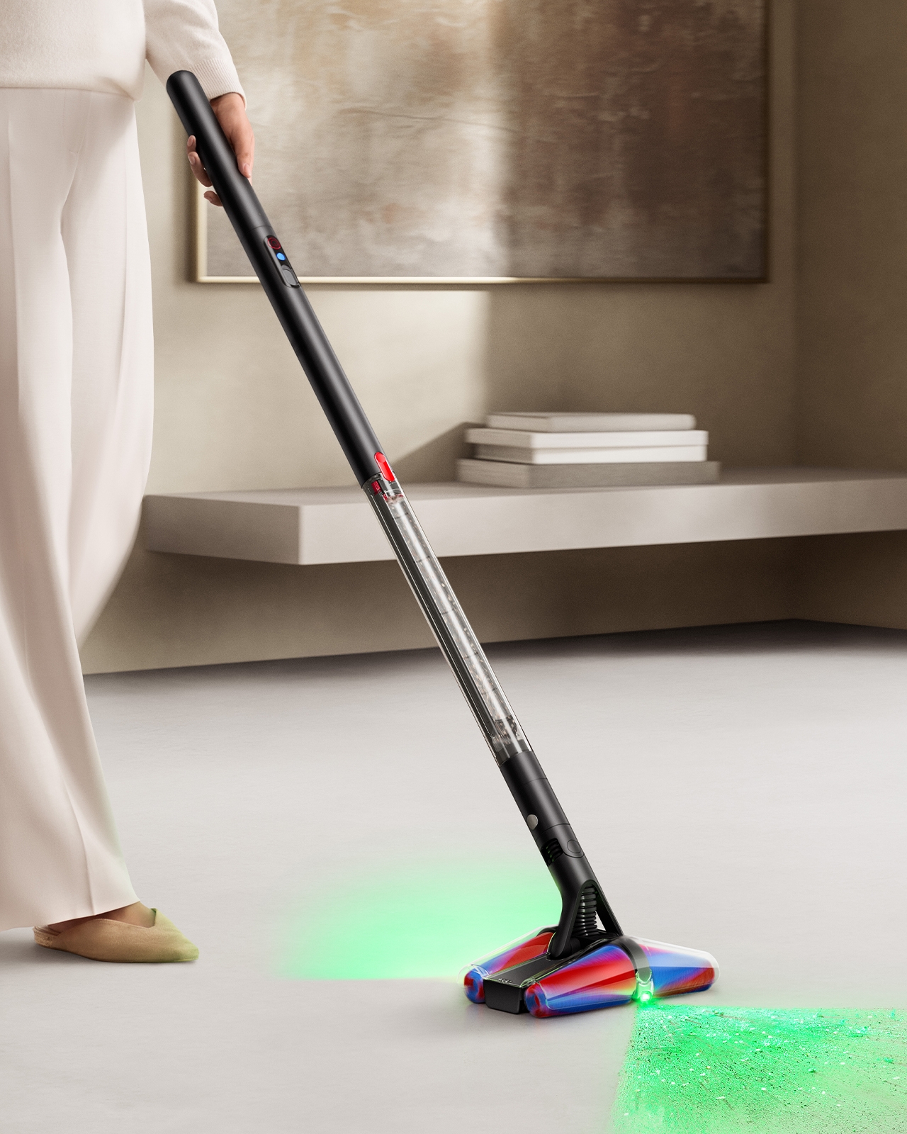 Model using the Dyson PencilVac cleaner across her home with illumination lights.