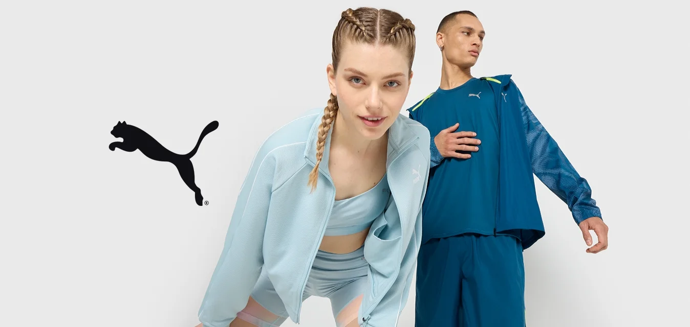 Giacca sportiva azzurro chiaro e set di pantaloni corti con finitura testurizzata. Il modello maschile indossa un completo blu con dettagli in rete e accenti neon.