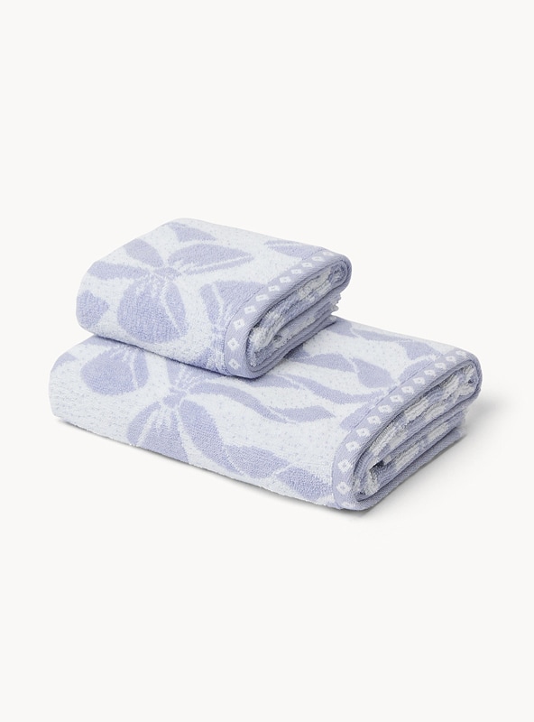 Asciugamano bicolor in spugna di cotone con fantasia fiocchi