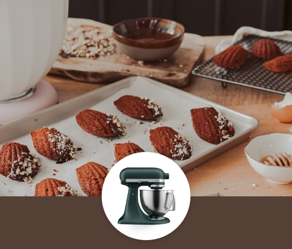 Chocolate dipped madeleines with chopped hazelnuts