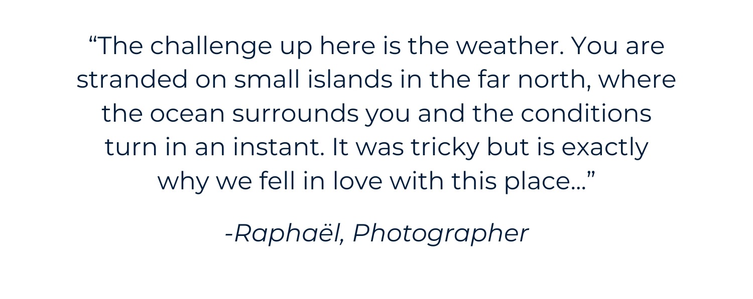 an image of a woman in a blue jacket holding a snowboard