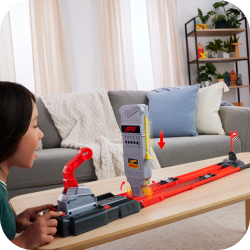 an image of a girl playing with a toy train set