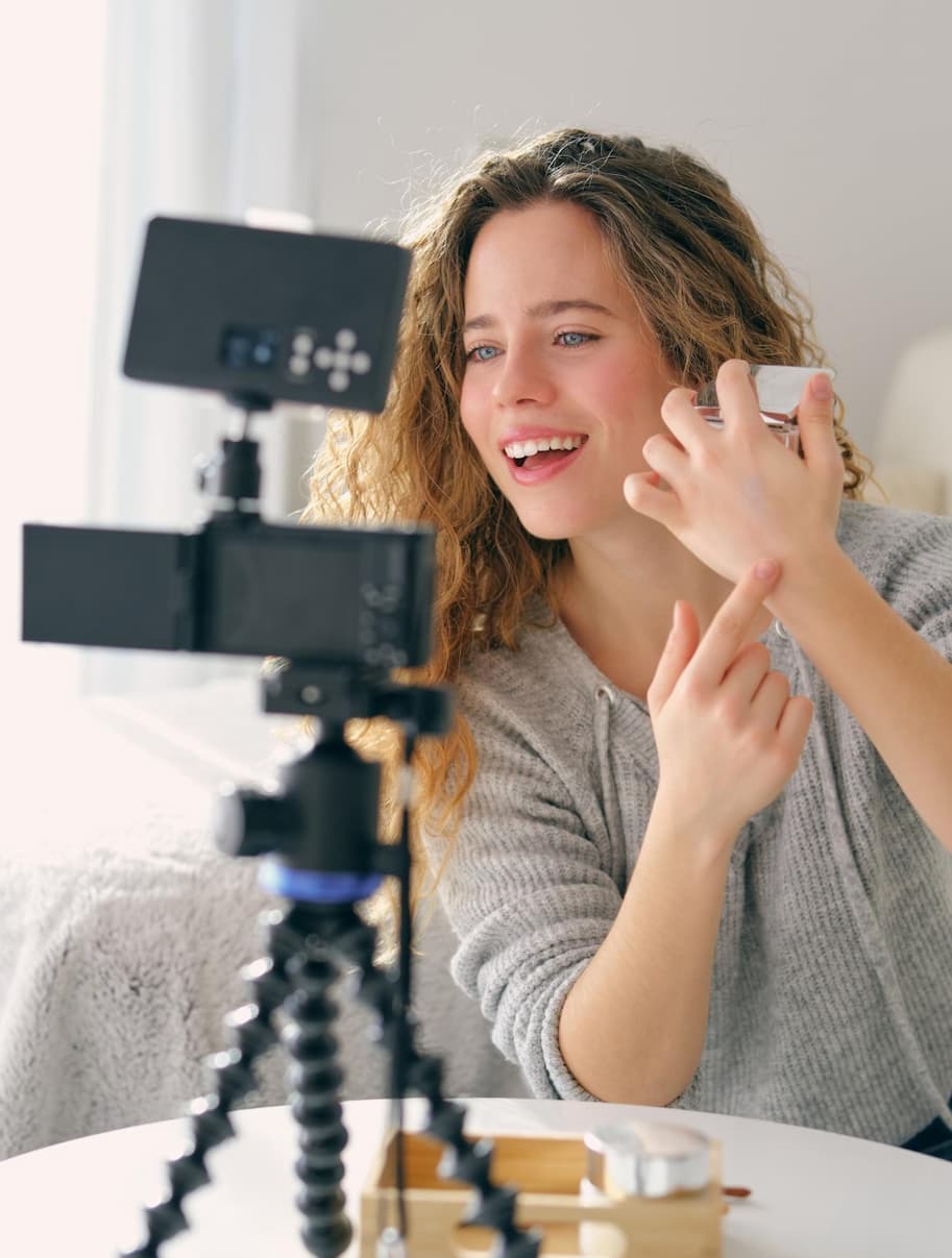 an image of a woman is sitting at a table with a camera