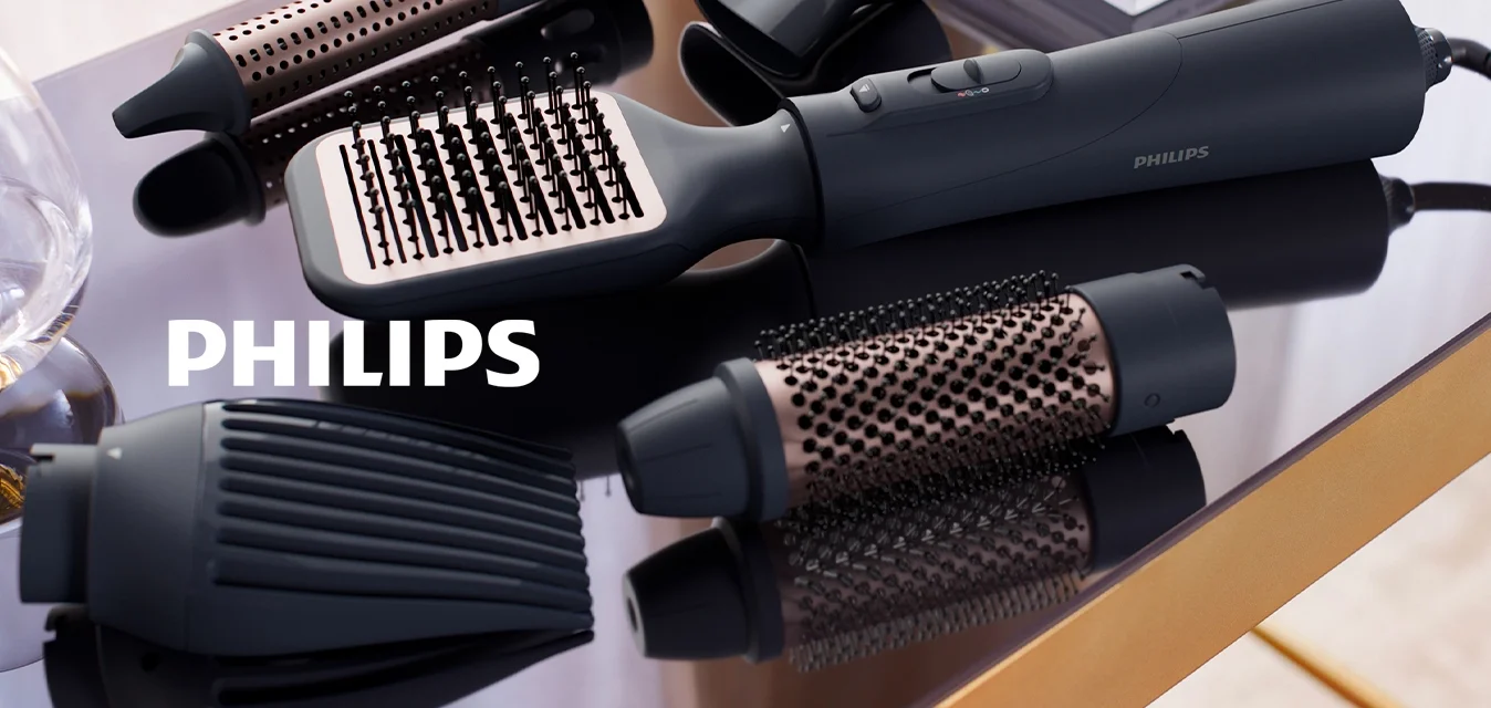 Strumento per acconciare i capelli con un corpo ergonomico nero, dotato di molteplici accessori intercambiabili in nero e oro rosa, caratterizzati da superfici testurizzate e aperture.