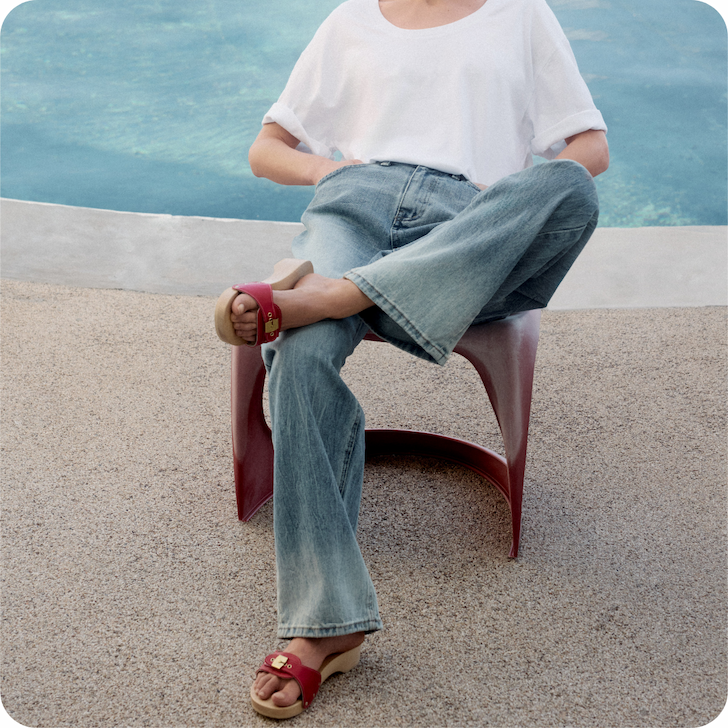 an image of a man sitting on a chair by a pool