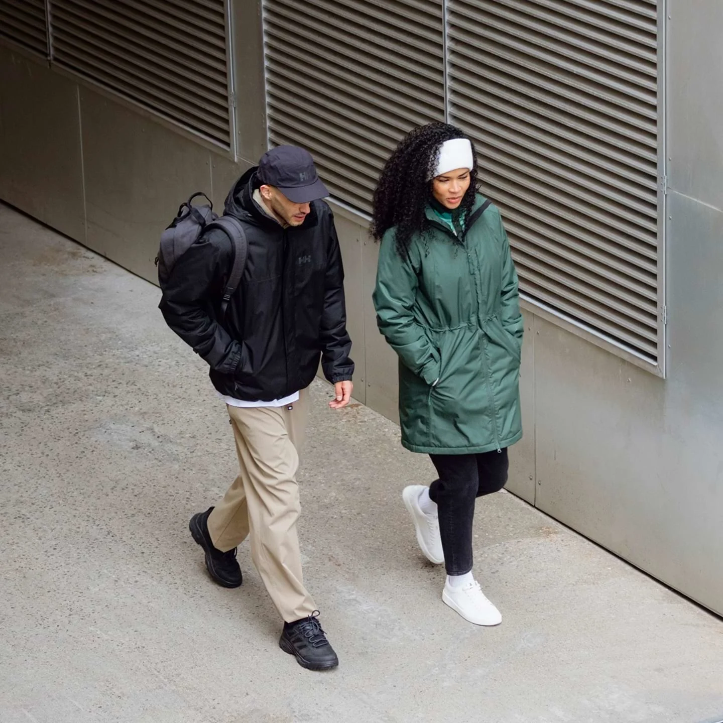 Two people wearing Helly Hansen rain jackets