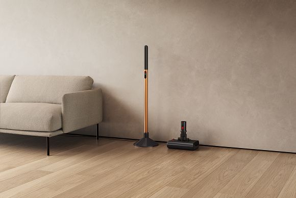 The Dyson PencilWash wand placed in its charging dock, and cleaner head in its drip tray.