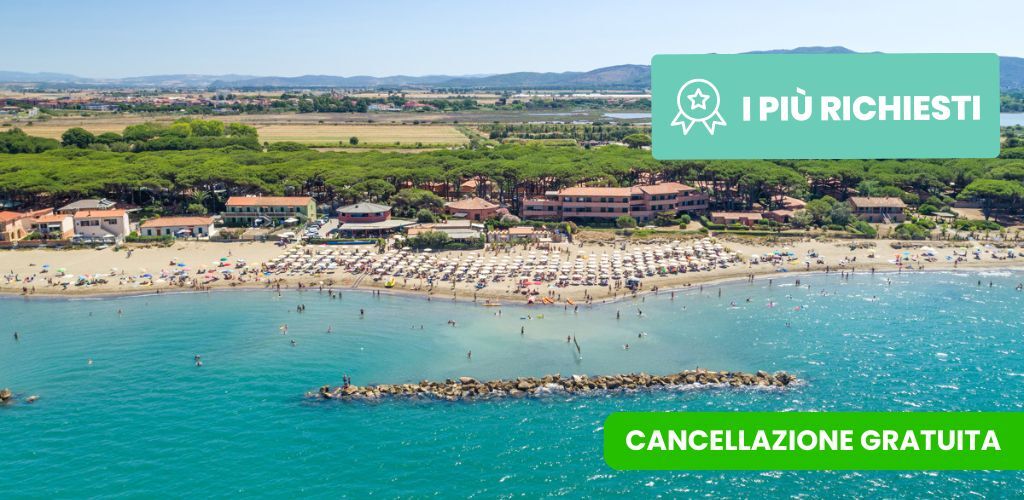 Aerial view of a busy Mediterranean beach resort with rows of sun umbrellas, turquoise sea, breakwater and pine trees