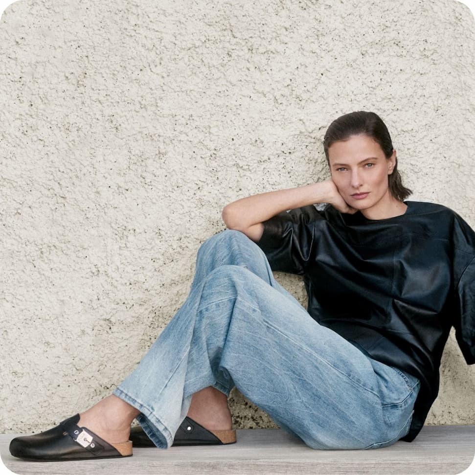 an image of a person sitting on a bench looking out at the ocean
