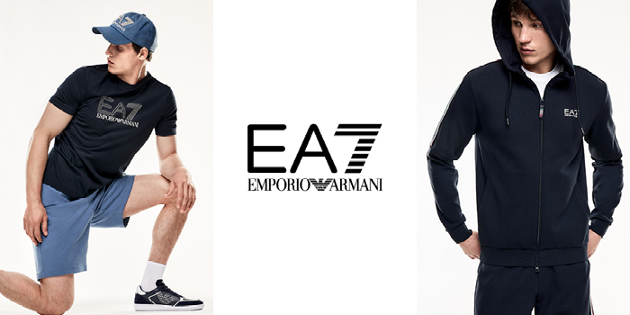 EA7 Emporio Armani logo between two male models in navy sportswear — t-shirt, cap and shorts at left; zip-up hoodie at right