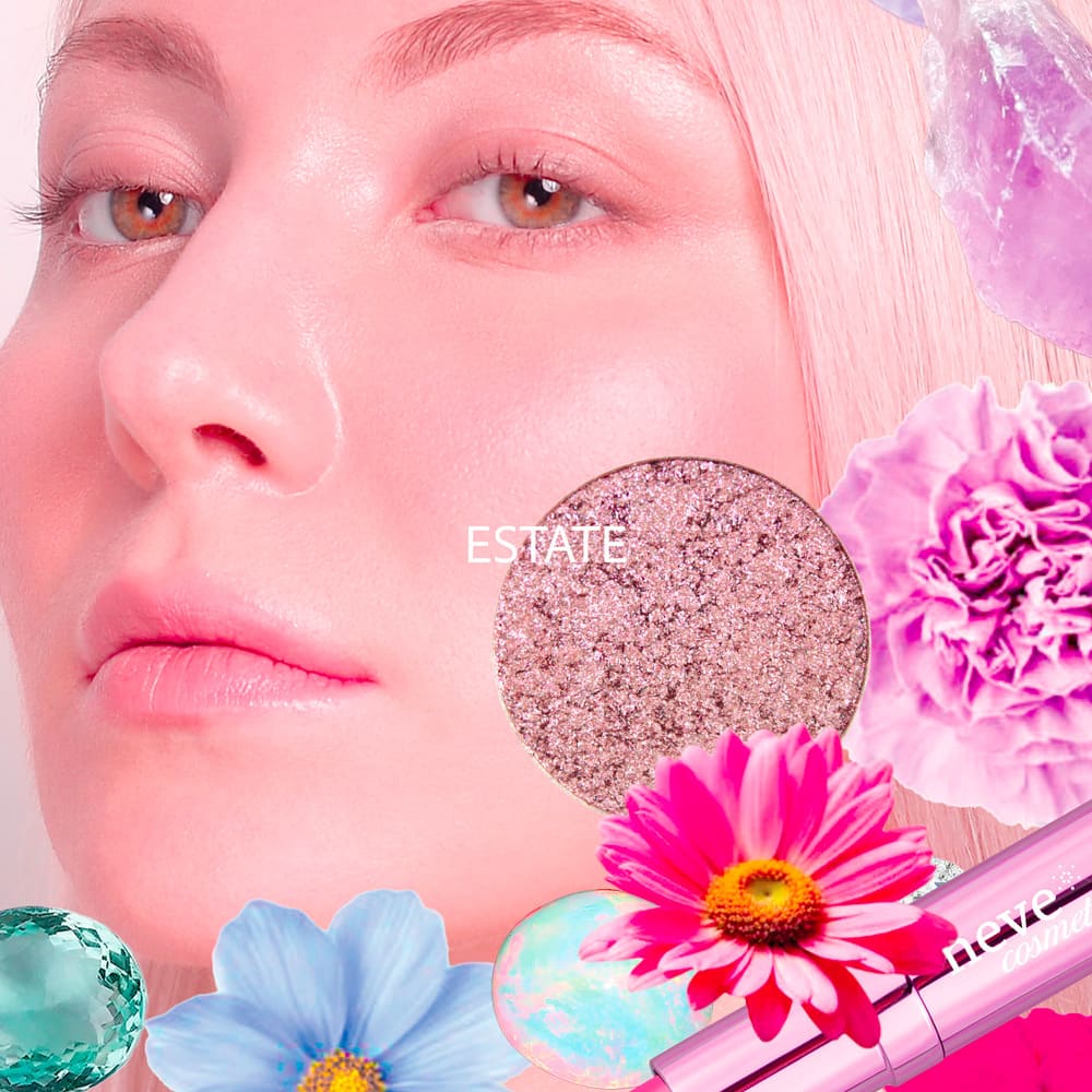 Close-up of a model's face with dewy pink makeup, glitter eyeshadow swatch, bright flowers and gemstones in a cosmetic advertisement