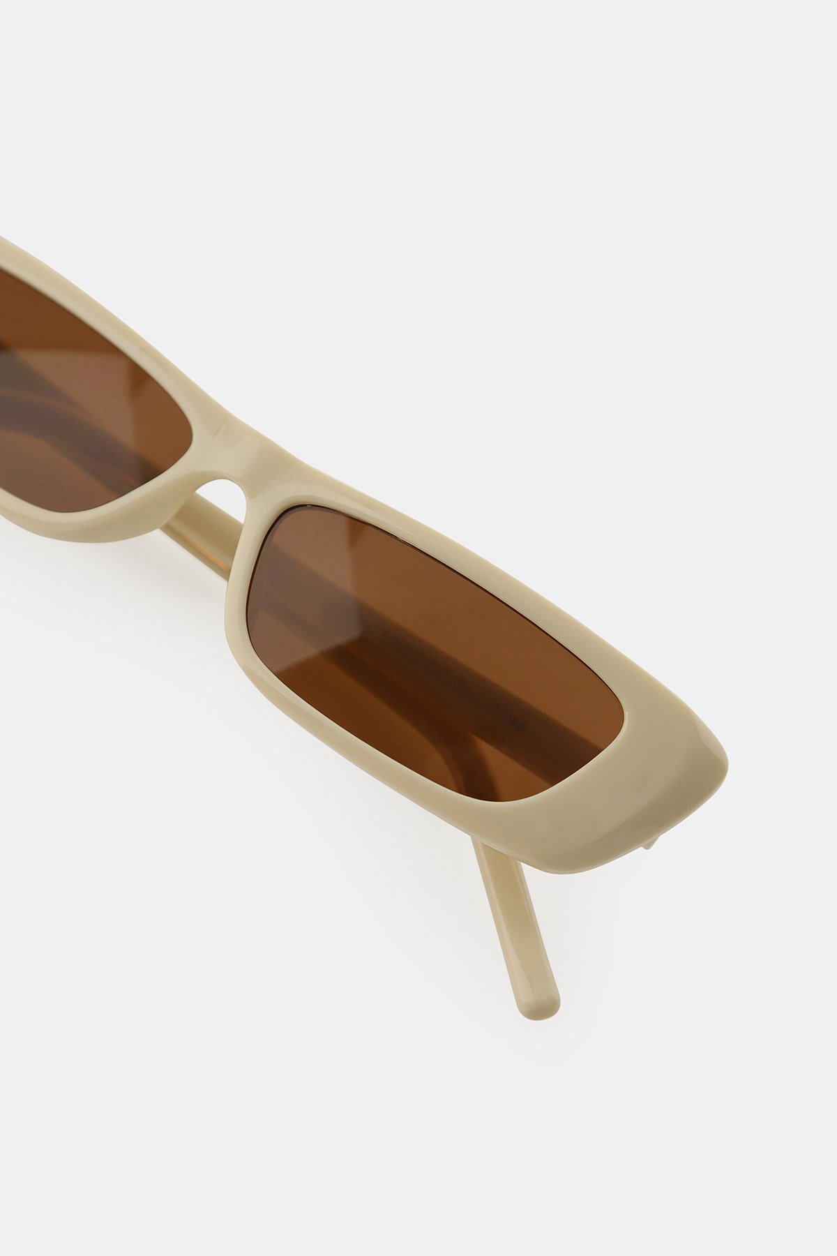 Beige rectangular sunglasses with brown tinted lenses on a white background, modern retro fashion accessory