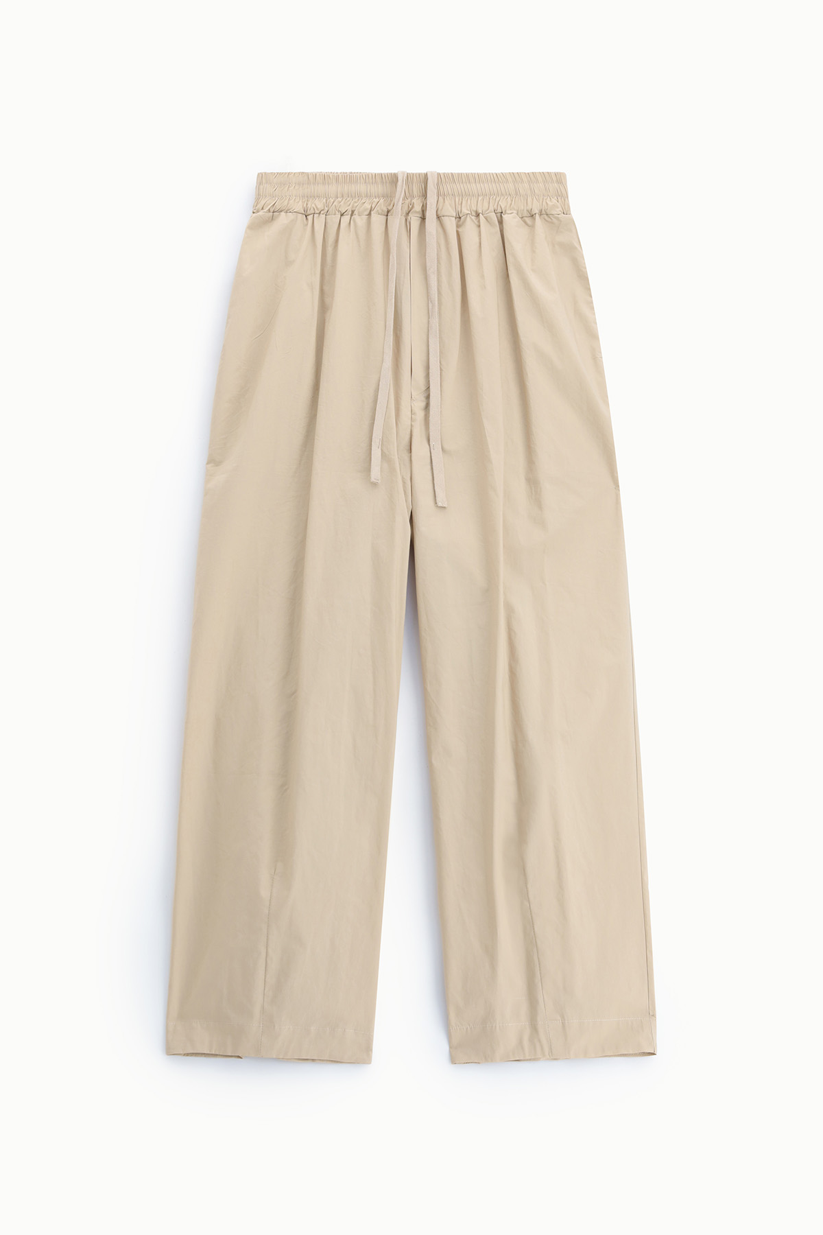Beige wide-leg drawstring trousers flat-lay on white background, elasticated waistband and relaxed fit